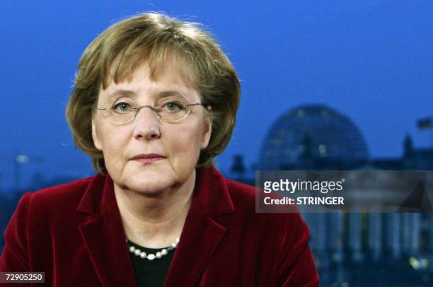German Chancellor Angela Merkel poses for photographers before recording her New Year address at the chancellery in Berlin 30 December 2006. The...