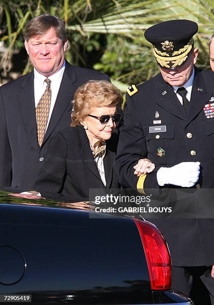 Palm Desert, UNITED STATES: Betty Ford , widow of Gerald Ford, is helped by by Major General Guy C. Swan III , Commanding General Joint Task Force...
