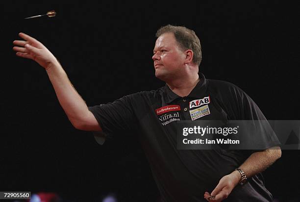 Raymond Van Barneveld of Holland throws against Andy Jenkins of England during the semi-finals of the Ladbrokes World Darts Championship at The...