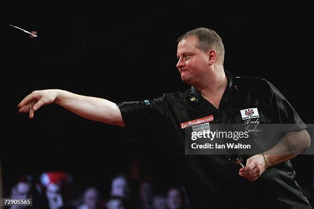 Andy Jenkins of England throws against Raymond Van Barneveld of Holland during the semi-finals of the Ladbrokes World Darts Championship at The...