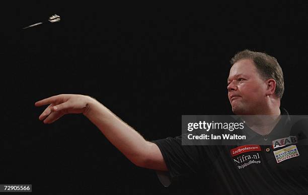 Raymond Van Barneveld of Holland throws against Andy Jenkins of England during the semi-finals of the Ladbrokes World Darts Championship at The...