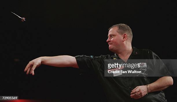 Andy Jenkins of England throws against Raymond Van Barneveld of Holland during the semi-finals of the Ladbrokes World Darts Championship at The...