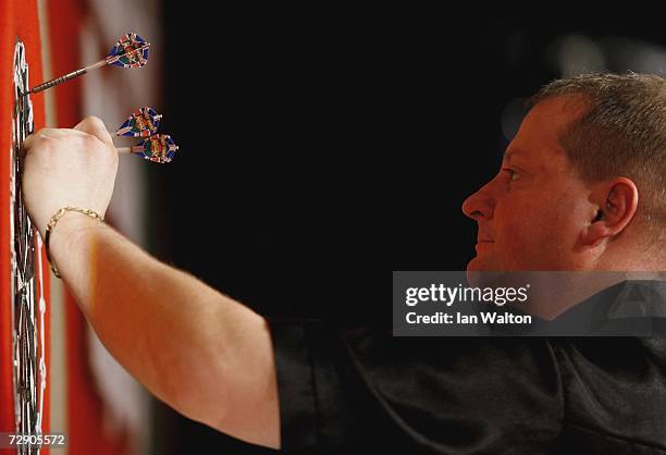 Andy Jenkins of England in action against Raymond Van Barneveld of Holland during the semi-finals of the Ladbrokes World Darts Championship at The...