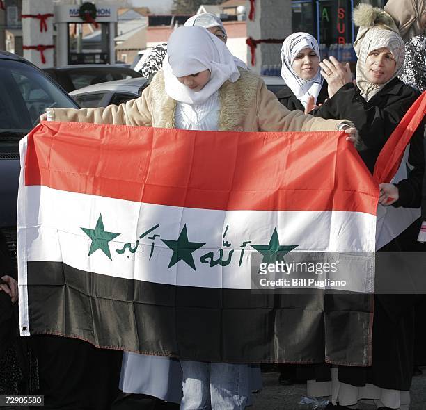 Iraqi American women celebrate the execution of former Iraqi leader Saddam Hussein the morning after his death December 30, 2006 in Dearborn,...