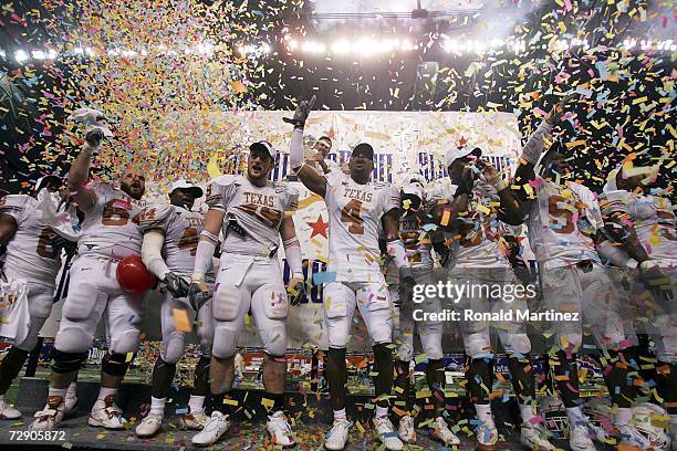 Kasey Studdard, Rashad Bobino, Brian Robison, Limas Sweed, Tim Crowder, and Brian Orakpo of the Texas Longhorns celebrate a 26-24 win against Iowa...