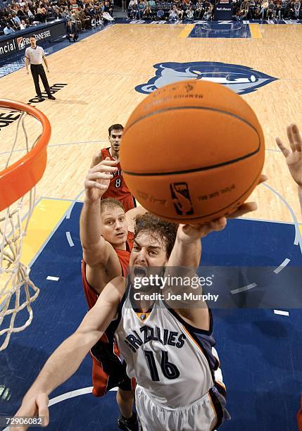 Pau Gasol of the Memphis Grizzlies shoots a layup past Rasho Nesterovic of the Toronto Raptors on December 30, 2006 at FedExForum in Memphis,...