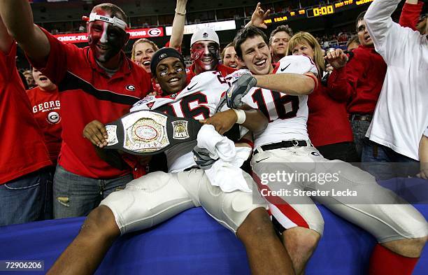 Brian Mimbs and teammate Kris Durham of the Georgia Bulldogs celebrate after a 31-24 victory over the Virginia Tech Hokies during the Chick-fil-a...