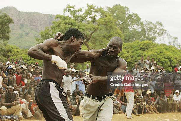 Mamanyouha Brown Mudzuli and Simon Nekampe fight during a traditional fist fighting match on December 29, 2006 in Tshaulu Village, Venda, South...