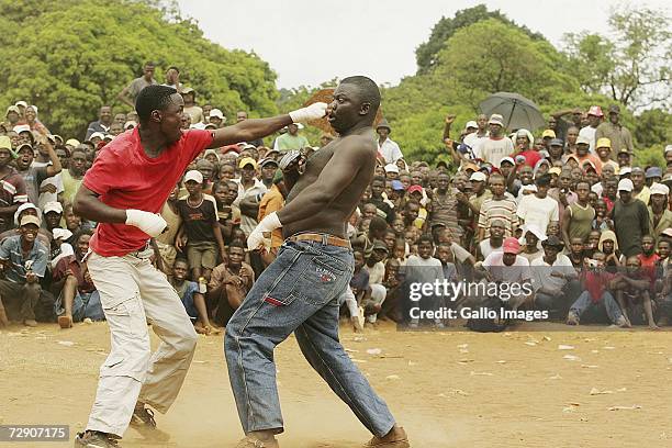 Mashudu Botswana Nengwenani punches Abram Abu Rabali during a traditional fist fighting match on December 29, 2006 in Tshaulu Village, Venda, South...