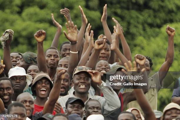 Fans celebrates during a traditional fist fighting match on December 29, 2006 in Tshaulu Village, Venda, South Africa. Venda's traditional fights or...