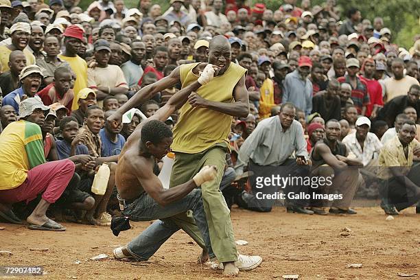 Mamanyuwa Rudzani and Madzhuta Baveher fight during a traditional fist fighting match on December 29, 2006 in Tshaulu Village, Venda, South Africa....
