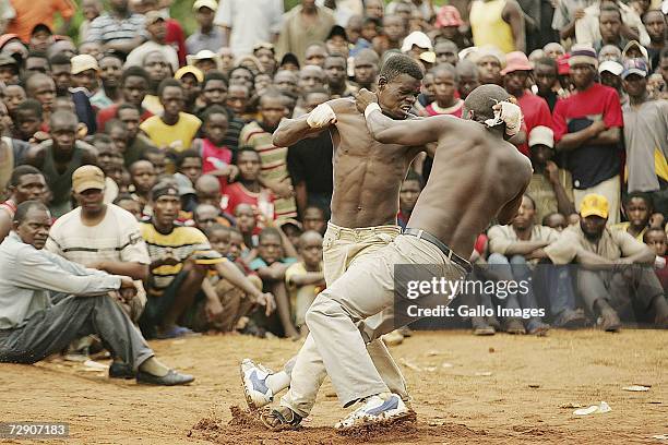 Vincent Mudzuni and Azwindllie Ndou fight during a traditional fist fighting match on December 29, 2006 in Tshaulu Village, Venda, South Africa....