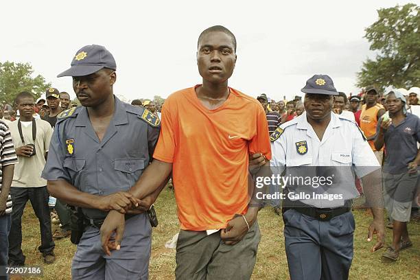 Police arrests a fihgter who stabbed another fighter during a traditional fist fighting match on December 29, 2006 in Tshaulu Village, Venda, South...