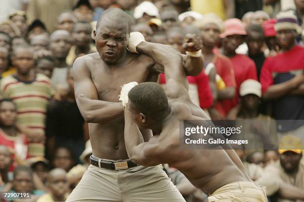 Vincent Mudzuni and Azwindllie Ndou fight during a traditional fist fighting match on December 29, 2006 in Tshaulu Village, Venda, South Africa....