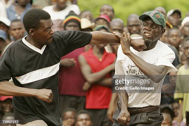 MNetshishivhe Mpanadeli hits Ramuima Miliigoni during a traditional fist fighting match on December 29, 2006 in Tshaulu Village, Venda, South Africa....