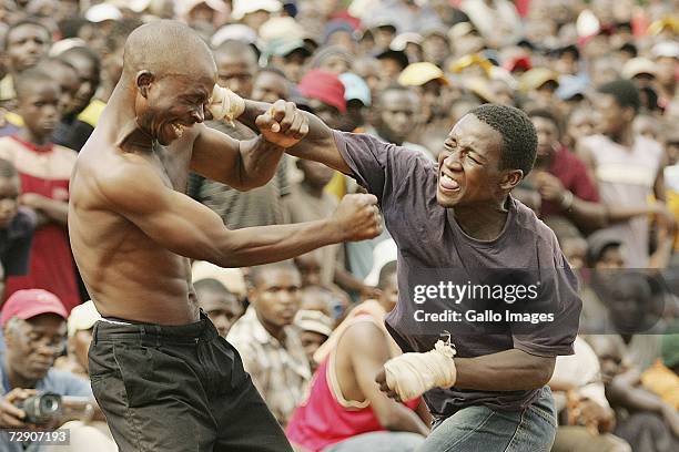 Mmabulawa Milinngoni and Thomas Mabilla fight during a traditional fist fighting match on December 29, 2006 in Tshaulu Village, Venda, South Africa....
