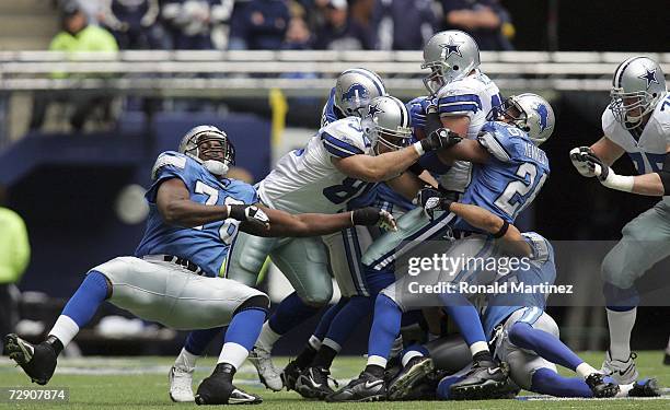 Tight end Jason Witten of the Dallas Cowboys is tackled by Kenoy Kennedy of the Detroit Lions at Texas Stadium on December 31, 2006 in Irving, Texas.