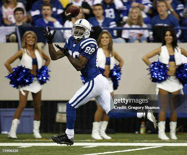 Marvin Harrison of the Indianapolis Colts catches a fourth quarter touchdown pass against the Miami Dolphins at the RCA Dome December 31, 2006 in...