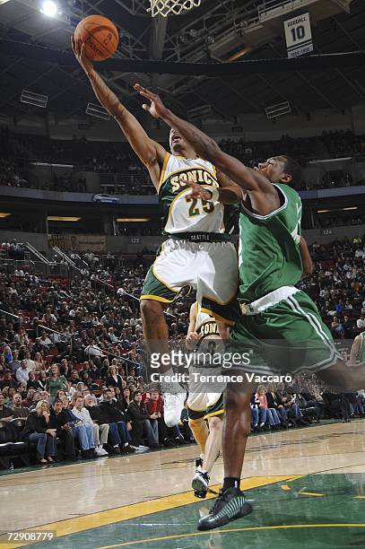 Earl Watson of the Seattle SuperSonics goes to the basket against the defense of Tony Allen of the Boston Celtics on December 31, 2006 at the Key...