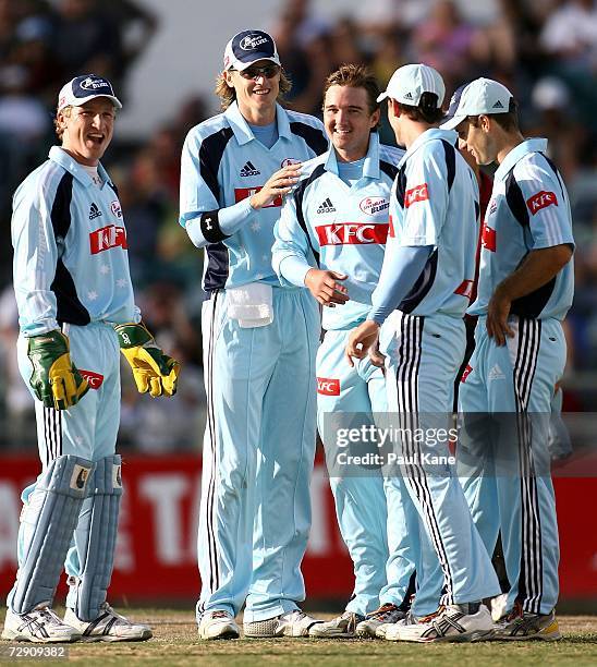 Nathan Bracken of the Blues congratulates Nathan Hauritz after taking the wicket of Scott Meuleman during the Twenty20 Big Bash between the Western...