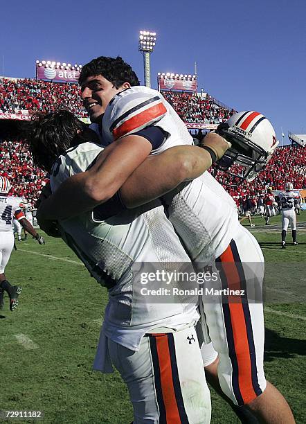 Quarterback Brandon Cox of the Auburn Tigers celebrates with Joe Cope after a 17-14 win against the Nebraska Cornhuskers during the AT&T Cotton Bowl...