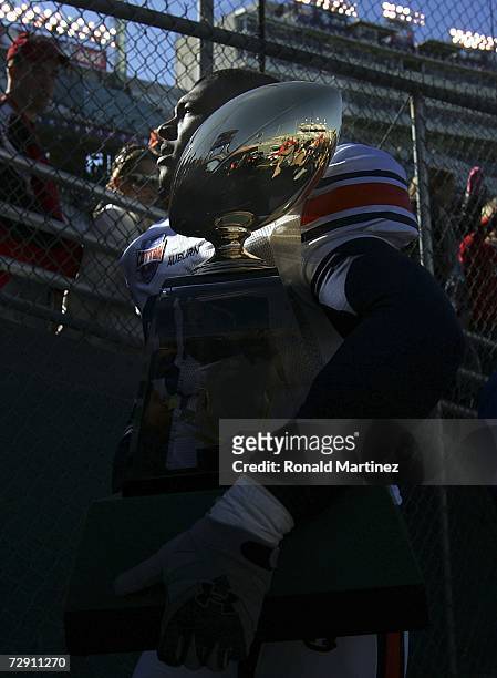 Linebacker Alonzo Horton of the Auburn Tigers walks off the field with the AT&T Cotton Bowl Classic trophy after a 17-14 win against the Nebraska...