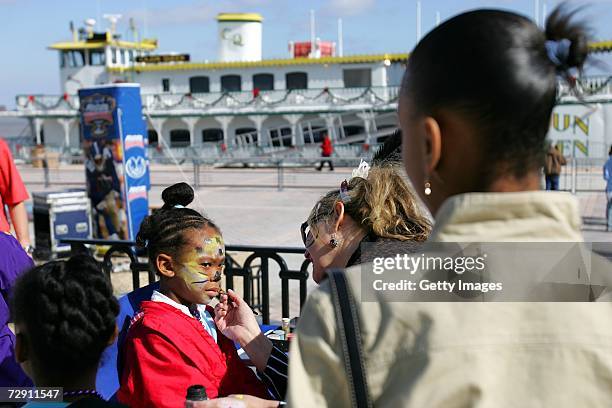 Fans get their faces painted at the Allstate Sugar Bowl Fan Fest on January 1, 2007 at the River Walk in New Orleans, Louisiana.