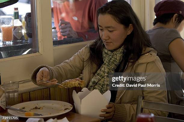 Lorilee Chin puts her leftover San Francisco crepe in a paper take out container at the Crepevine on January 1, 2007 in Oakland, California. In an...