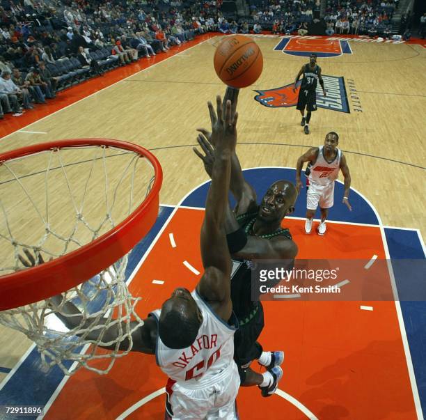 Kevin Garnett of the Minnesota Timberwolves shoots over Emeka Okafor of the Charlotte Bobcats on January 1, 2007 at the Charlotte Bobcats Arena in...