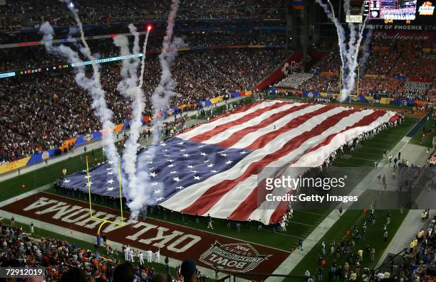 The United States flag covers the field during the national anthem before the Tostito's Fiesta Bowl between the Oklahoma Sooners and the Boise State...