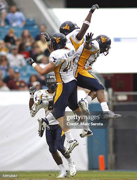 The West Virginia Mountaineers defense celebrate during a game against the Georgia Tech Yellow Jackets in the Toyota Gator Bowl at Alltel Stadium...