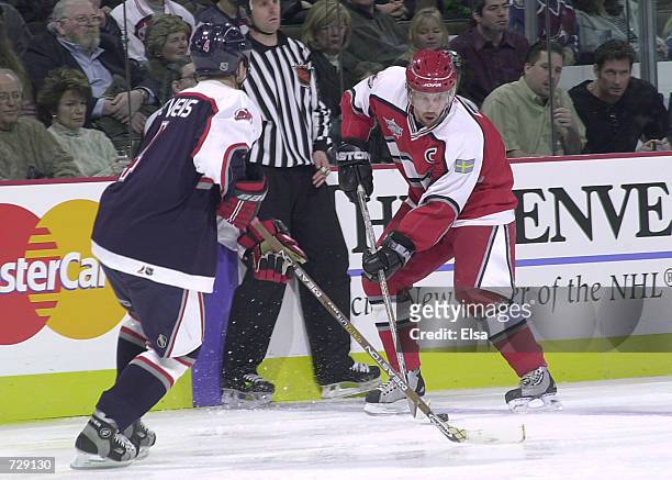 Peter Forsberg of the World Allstars takes the puck down the ice as Scott Stevens of the North American Allstars defends during the NHL Allstar game...