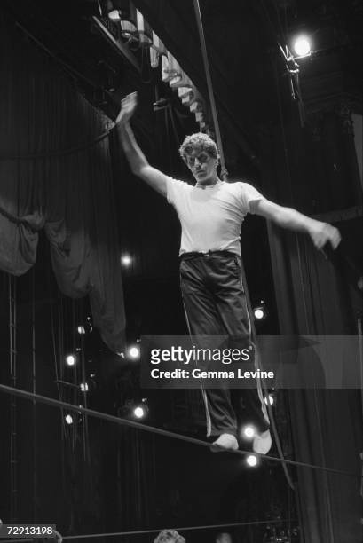 English actor and singer Michael Crawford walks the tightrope during a rehearsal for a BBC production of the musical 'Barnum', circa 1986.
