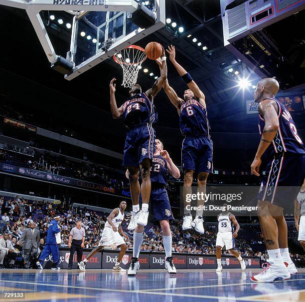 Kenyon Martin of the New Jersey Nets leaps to help teammate Stephen Jackson to make the basket during the game against the Washington Wizards at the...