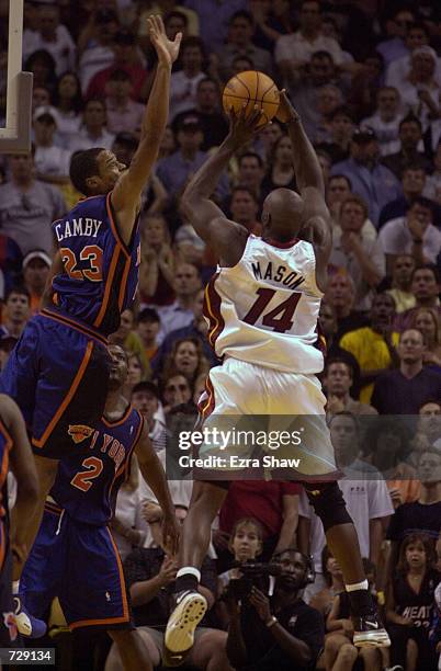 Marcus Camby of the New York Knicks blocks a shot taken by Anthony Mason of the Miami Heat at the end of regulation at the American Airlines Arena in...
