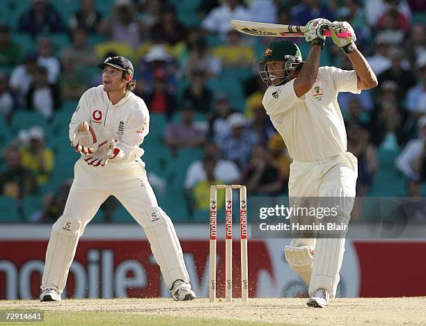 Andrew Symonds of Australia bats, watched by wicketkeeper Chris Read of England during day two of the fifth Ashes Test Match between Australia and...