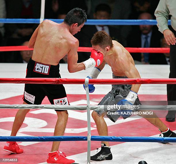 Champion Cristian Mijares of Mexico hits a right uppercut to Japanese challenger Katsushige Kawashima in the 9th round of their WBC super flyweight...