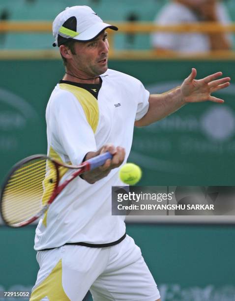 Tennis player Stefano Galvani of Italy plays a return to his Belgian opponent Xavier Malisse during the second round match in the Chennai Open 2007,...