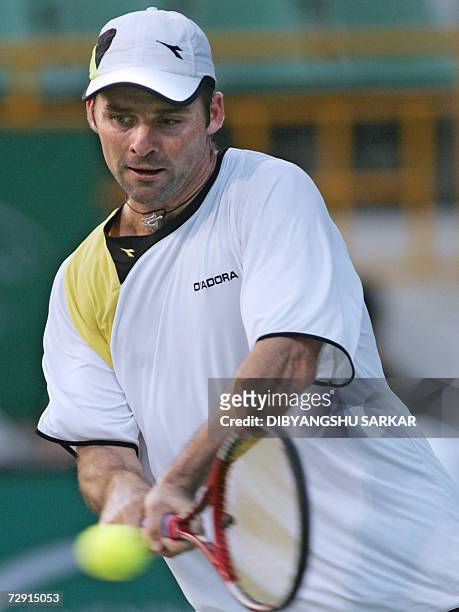 Tennis player Stefano Galvani of Italy plays a return to his Belgian opponent Xavier Malisse during the second round match in the Chennai Open 2007,...