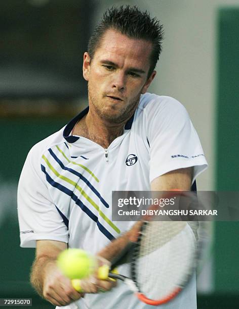 Tennis player Xavier Malisse of Belgium plays a return to his Italian opponent Stefano Galvani during their second round match in the Chennai Open...