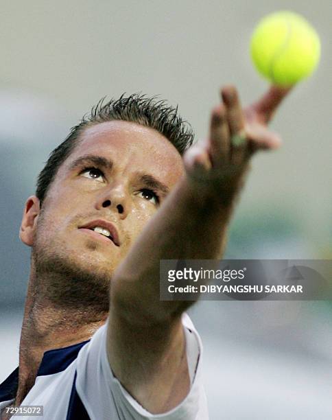 Tennis player Xavier Malisse of Belgium prepares to serve against his Italian opponent Stefano Galvani during their second round match in the Chennai...
