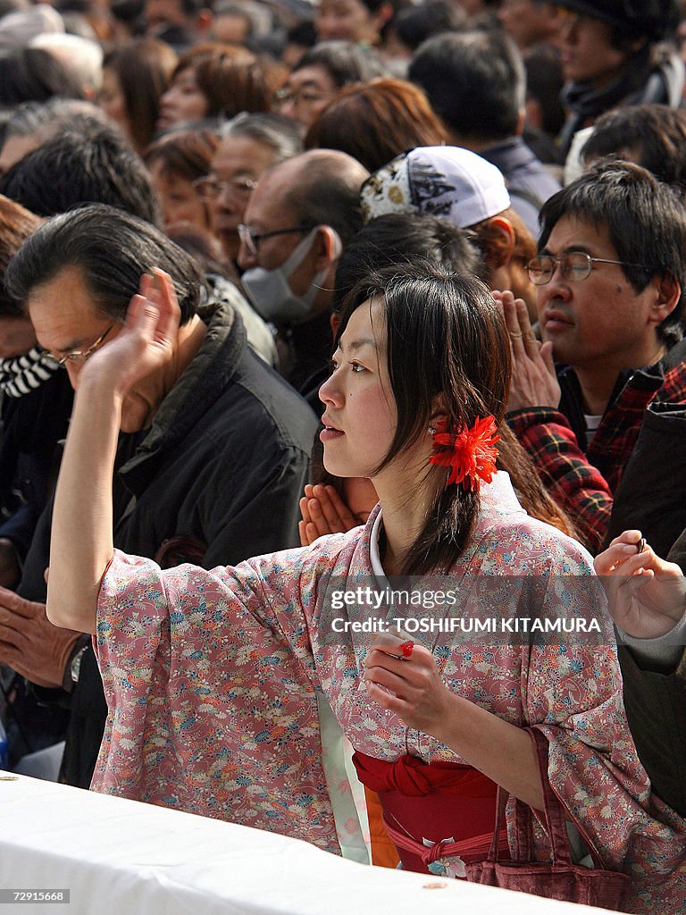 A young woman wearing a traditional kimo