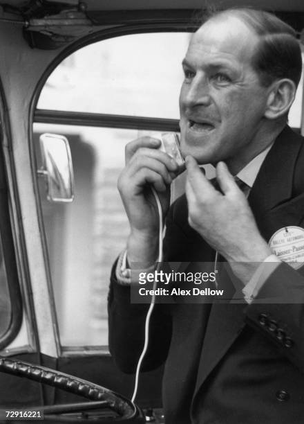 The driver of the press coach has a hurried shave at the wheel in a break from covering the Monte Carlo Rally, 1954. Original publication: Picture...