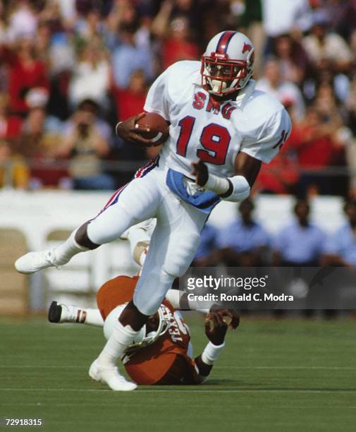 Eric Dickerson of the SMU Mustangs carries the ball during a game against the University of Texas Longhorns on October 23, 1982 in Austin, Texas. The...