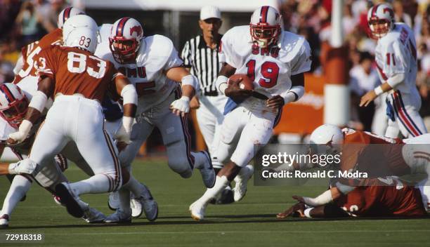 Eric Dickerson of the SMU Mustangs carries the ball during a game against the University of Texas Longhorns on October 23, 1982 in Austin, Texas. The...