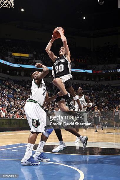 Manu Ginobili of the San Antonio Spurs drives to the basket against Trenton Hassell of the Minnesota Timberwolves in NBA action January 3, 2007 at...