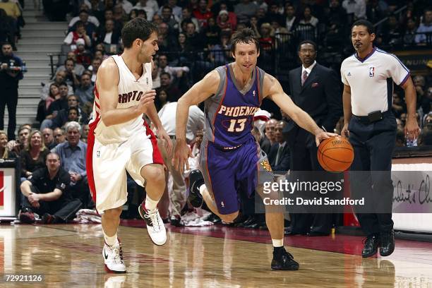 Steve Nash of the Phoenix Suns runs the ball up court as he is defended by Jose Calderon of the Toronto Raptors on January 3, 2007 at the Air Canada...