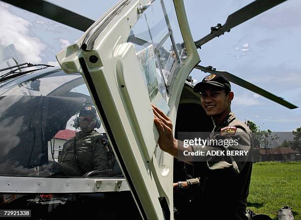 An Indonesian policeman prepares to board a helicopter as search and rescue teams are ongoing in their search for the missing Adam air plane in...