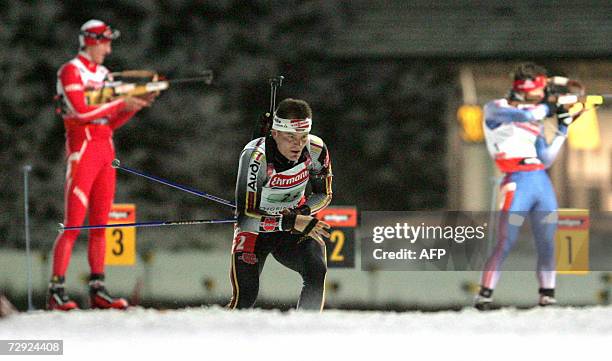 Norway's Lars Berger, Germany's Sven Fischer and Russia's Maxim Tchoudov compete in the Men's 4x7,5 km relay event of the Biathlon World Cup in...