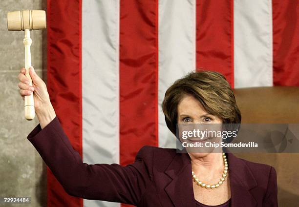 Speaker of the House Nancy Pelosi holds up the Speaker's gavel after being elected as the first woman Speaker during a swearing in ceremony for the...